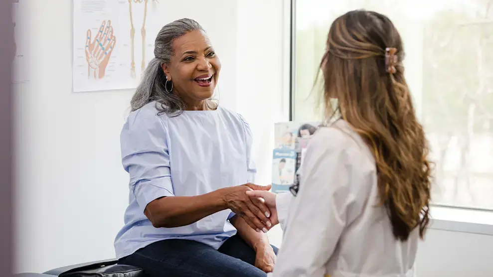 primary care doctors near syracuse ny compassionate family medicine doctor talking with patient.webp